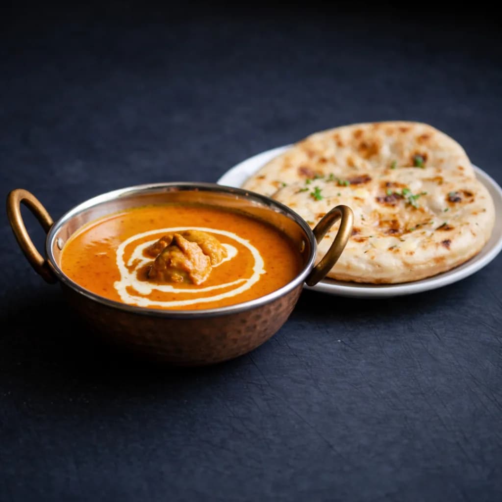 Butter chicken curry served with naan bread